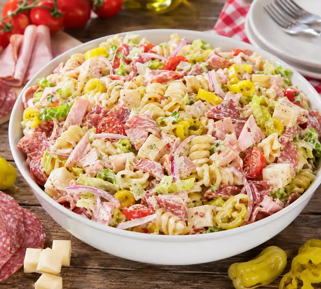 Grinder pasta salad with deli meats provolone cheese rotini pasta lettuce tomatoes banana peppers and creamy dressing