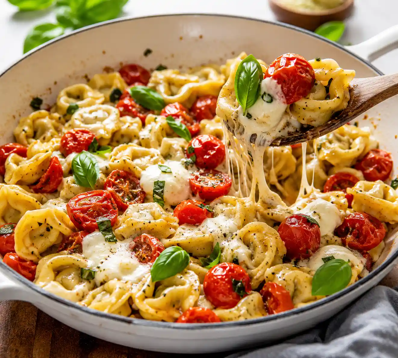 Caprese tortellini skillet with cheese tortellini cherry tomatoes fresh mozzarella basil and garlic sauce