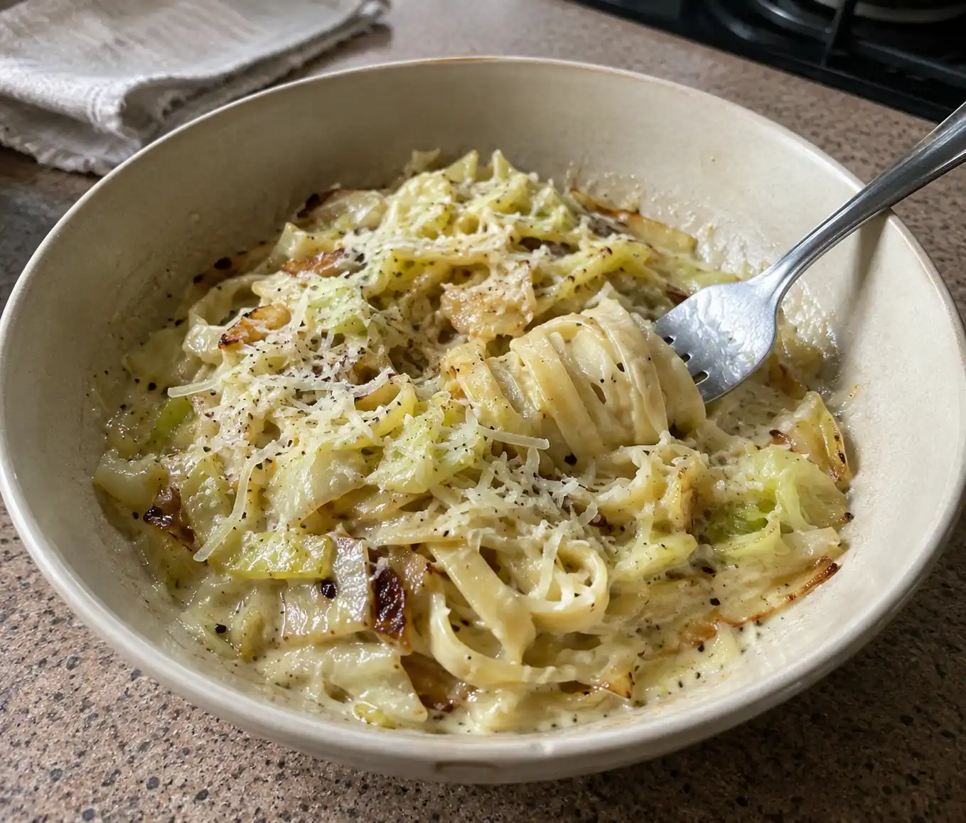 Bowl of creamy cabbage alfredo pasta with caramelized cabbage and parmesan
