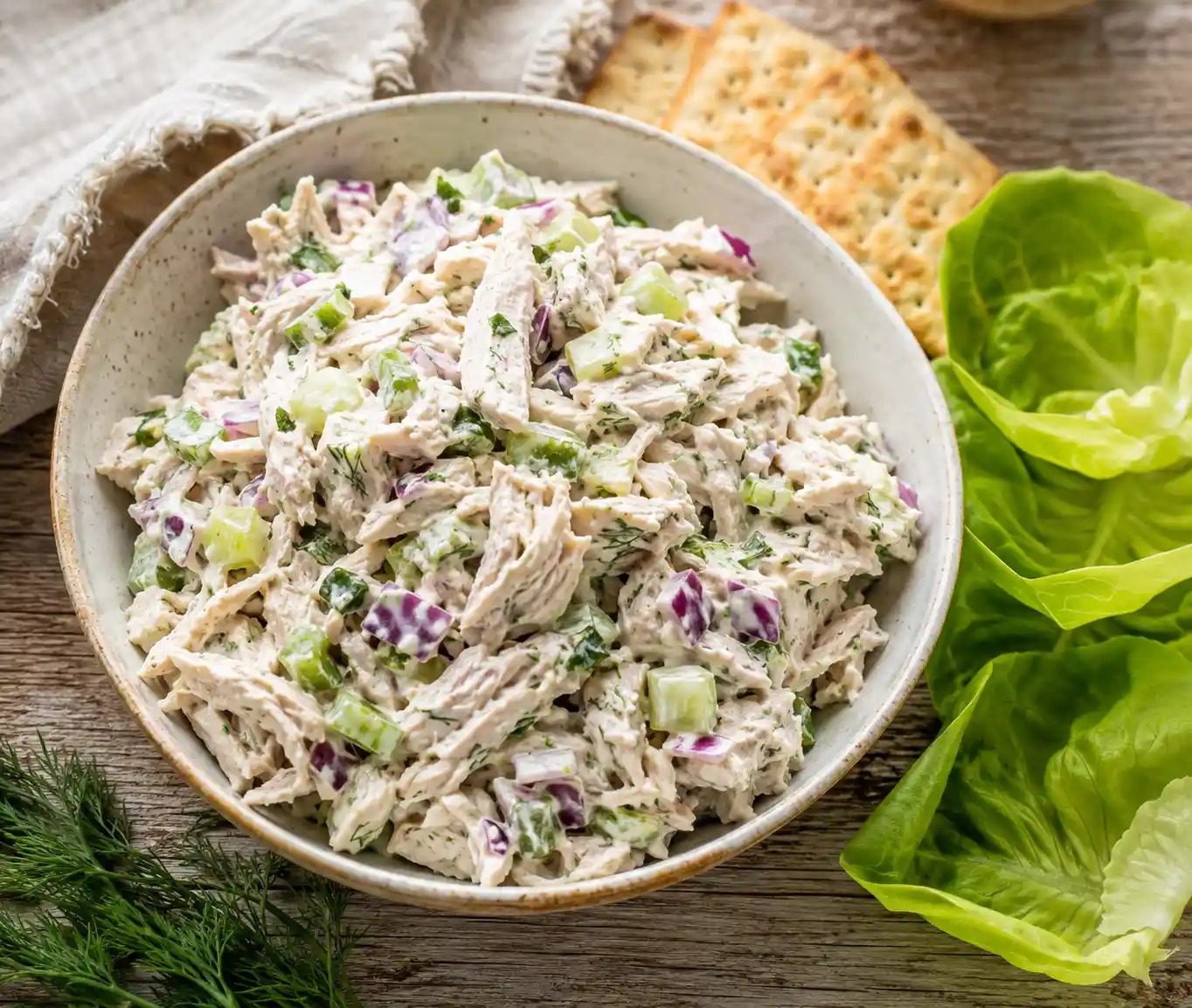 High Protein Greek Yogurt Chicken Salad with celery and herbs served in a white bowl with crackers