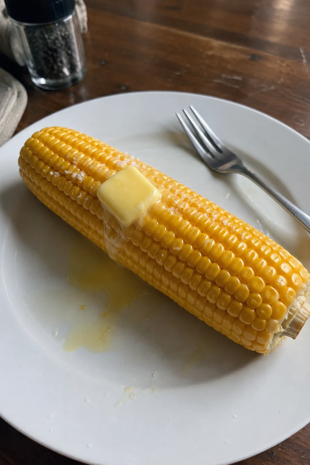 Corn on the cob served with melted butter and a sprinkle of salt