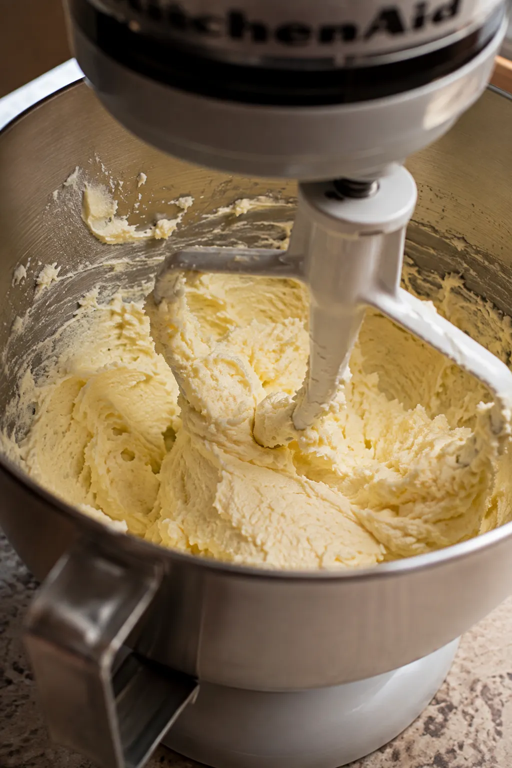 Butter and sugar being beaten together into a light fluffy texture for peach cake batter